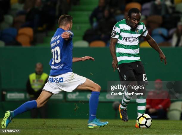 Sporting's forward Seydou Doumbia vies with Feirense's midfielder Luis Aurelio during the Portuguese League football match between Sporting CP and CD...