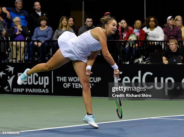 Lesley Kerkhove of the Netherlands serves to Venus Williams and Serena Williams of Team USA while competing in a doubles match during the first round...