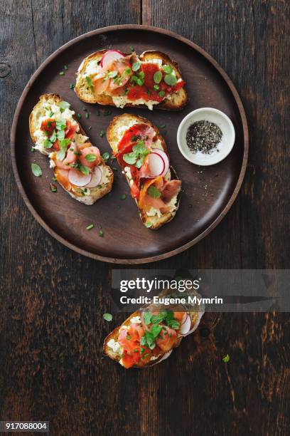 bruschetta with smoked trout and mascarpone scrambled eggs - bruschetta stock pictures, royalty-free photos & images