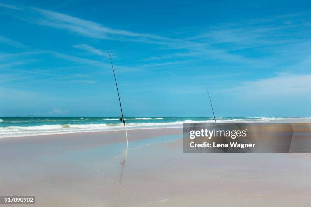 fishing rods propped on endless beach - ニュースムーナ・ビーチ ストックフォトと画像