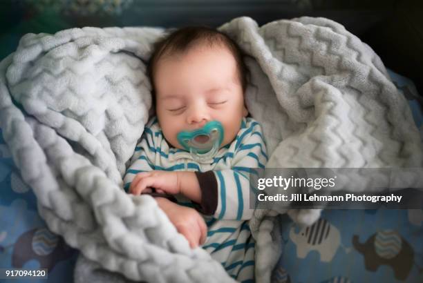 newborn baby sleeps soundly with pacifier - baby elephant stock-fotos und bilder