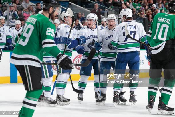 Jake Virtanen, Derrick Pouliot, Reid Boucher and Ben Hutton of the Vancouver Canucks celebrate a goal against the Dallas Stars at the American...