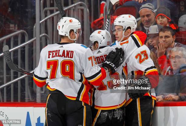 Micheal Ferland , Johnny Gaudreau and Sean Monahan of the Calgary Flames celebrate a goal against the New Jersey Devils on February 8, 2018 at...