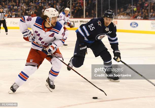 New York Rangers Right Wing Mats Zuccarello skates with the puck as Winnipeg Jets Center Mark Scheifele gives chase during a NHL game between the...
