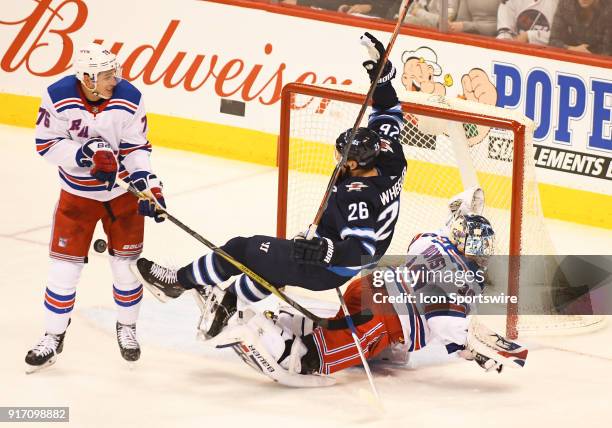 Winnipeg Jets Right Wing Blake Wheeler is called for goaltender interference on the collision with New York Rangers Goalie Henrik Lundqvist during a...