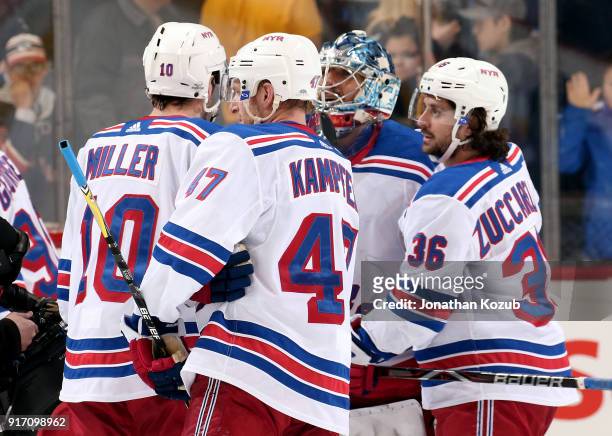 Miller, Steven Kampfer and Mats Zuccarello of the New York Rangers congratulate goaltender Henrik Lundqvist following a 3-1 victory over the Winnipeg...