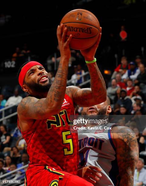 Malcolm Delaney of the Atlanta Hawks draws a foul from Jameer Nelson of the Detroit Pistons at Philips Arena on February 11, 2018 in Atlanta,...