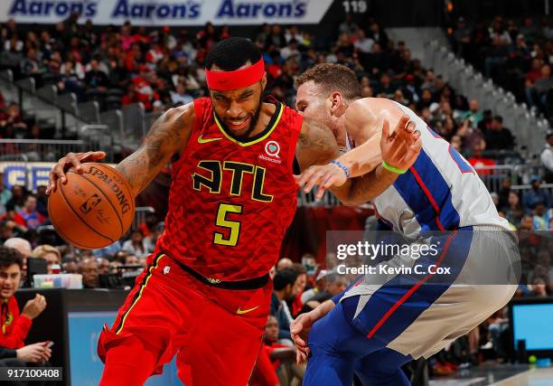 Malcolm Delaney of the Atlanta Hawks drives against Blake Griffin of the Detroit Pistons at Philips Arena on February 11, 2018 in Atlanta, Georgia....