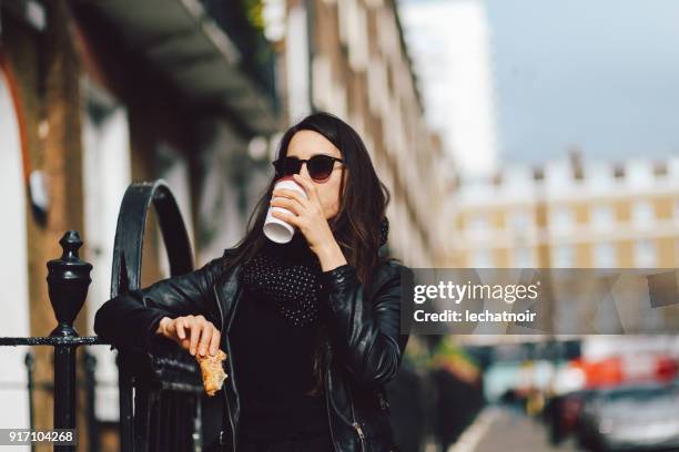 portrait of a young woman in london having coffee on the go - snacking on the go stock pictures, royalty-free photos & images