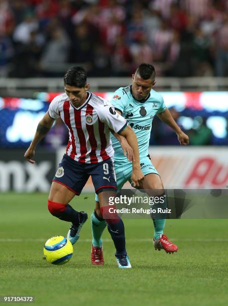 Alan Pulido of Chivas fights for the ball with Osvaldo Martinez of Santos during the 6th round match between Chivas and Santos Laguna as part of the...