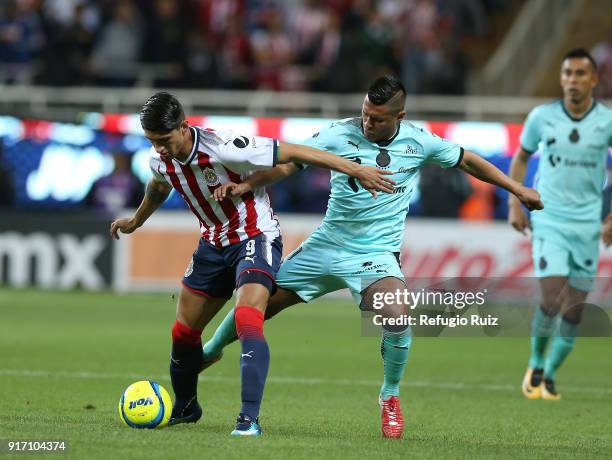 Alan Pulido of Chivas fights for the ball with Osvaldo Martinez of Santos during the 6th round match between Chivas and Santos Laguna as part of the...