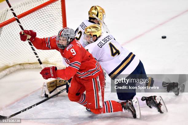 Notre Dame Fighting Irish defenseman Dennis Gilbert collides with Ohio State Buckeyes forward Tanner Laczynski near the goal during the game between...