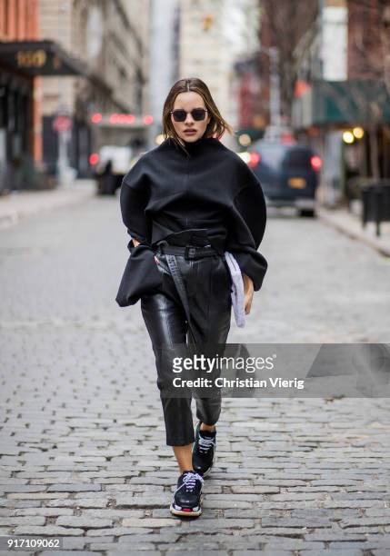 Maria Hatzistefanis wearing black Marissa Webb pants, Off White belt, Awake knit, black Balenciaga sneakers, white Balenciaga bag, Moncler sunglasses...