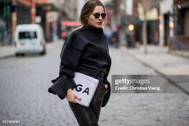 Maria Hatzistefanis wearing black Marissa Webb pants, Off White belt, Awake knit, black Balenciaga sneakers, white Balenciaga bag, Moncler sunglasses...