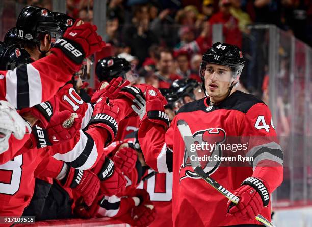 Miles Wood of the New Jersey Devils is congratulated by his teammates after scoring a first period goal against the Boston Bruins at Prudential...