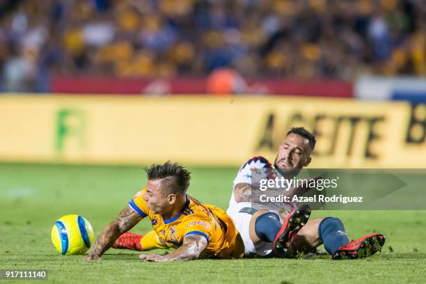 Eduardo Vargas of Tigres fights for the ball with Victor Aguilera of America during the 6th round match between Tigres UANL and America as part of...