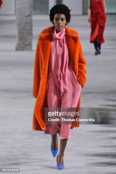 Alecia Morais walks the runway wearing Tibi Fall 2018 with makeup by Sarah Lucero and hair by Frank Rizzieri at Pier 17 on February 11, 2018 in New...