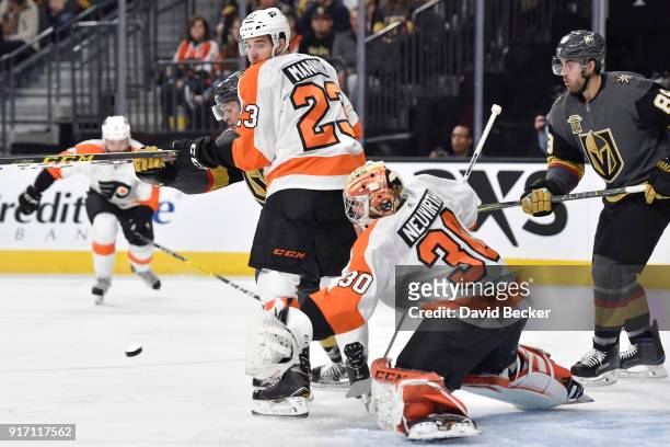 Brandon Manning defends while his Philadelphia Flyers teammate Michal Neuvirth makes a save against the Vegas Golden Knights during the game at...