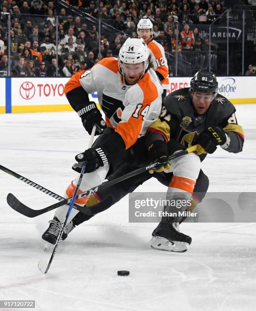 Sean Couturier of the Philadelphia Flyers and Jonathan Marchessault of the Vegas Golden Knights battle for the puck in the first period of their game...