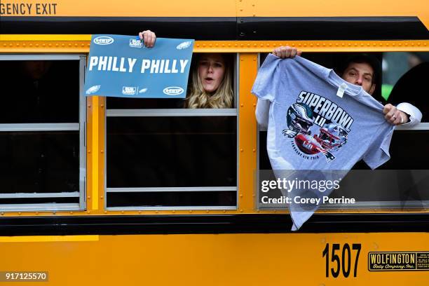 Fans riding a transportation bus display their Eagles paraphernalia in passing during festivities on February 8, 2018 in Philadelphia, Pennsylvania....