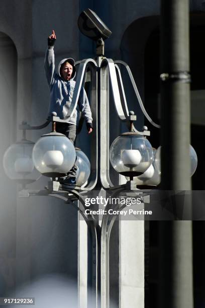 An Eagles fan elates after climbing a lamppost during festivities on February 8, 2018 in Philadelphia, Pennsylvania. The city celebrated the...