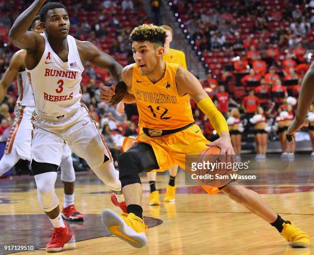 Hunter Maldonado of the Wyoming Cowboys drives against Amauri Hardy of the UNLV Rebels during their game at the Thomas & Mack Center on February 10,...