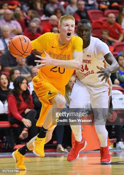 Hayden Dalton of the Wyoming Cowboys drives against Cheikh Mbacke Diong of the UNLV Rebels during their game at the Thomas & Mack Center on February...