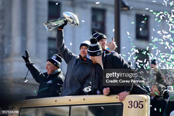 Team owner Jeffrey Lurie, with quarterbacks Nick Foles, Nate Sudfeld and Carson Wentz of the Philadelphia Eagles, acknowledge fans as Foles hoists...