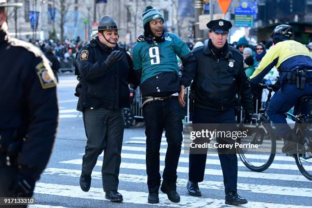 An Eagles fan is cuffed after climbing a convenience/newsstand during festivities on February 8, 2018 in Philadelphia, Pennsylvania. The city...
