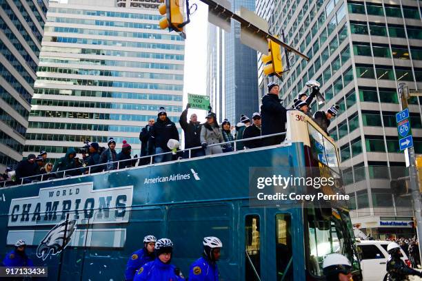 Team owner Jeffrey Lurie, with quarterbacks Nick Foles, Nate Sudfeld and Carson Wentz of the Philadelphia Eagles, acknowledge fans as Sudfeld hoists...