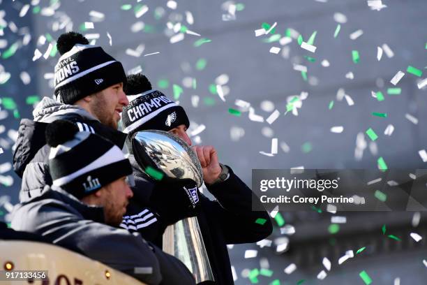 Quarterbacks Nick Foles, Nate Sudfeld and Carson Wentz of the Philadelphia Eagles, acknowledge fans as Sudfeld hoists the Vince Lombardi Trophy atop...