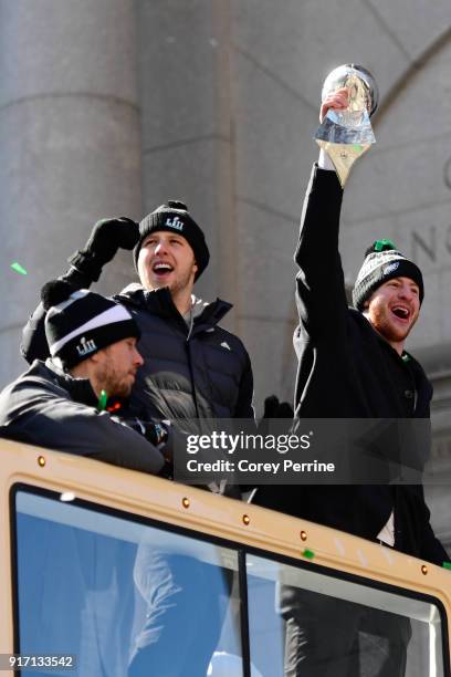 Quarterbacks Nick Foles, Nate Sudfeld and Carson Wentz of the Philadelphia Eagles, acknowledge fans as Wentz hoists the Vince Lombardi Trophy atop a...