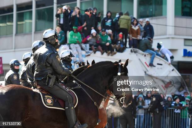 Mounted police are shown at the tail end of the parade as Eagles fans look on atop a garbage truck during festivities on February 8, 2018 in...