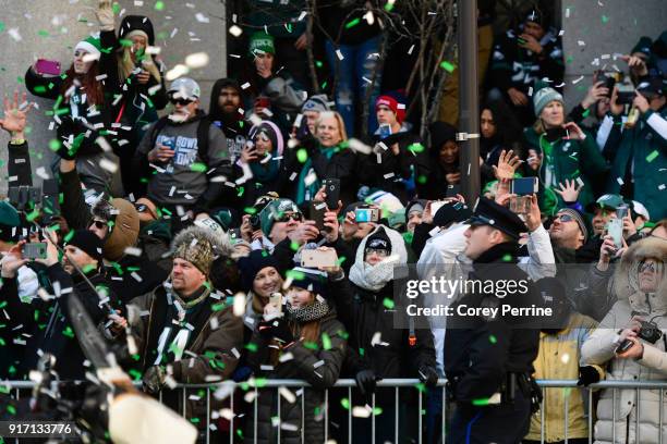Eagles fans watch busses carrying the Philadelphia Eagles team pass by during festivities on February 8, 2018 in Philadelphia, Pennsylvania. The city...