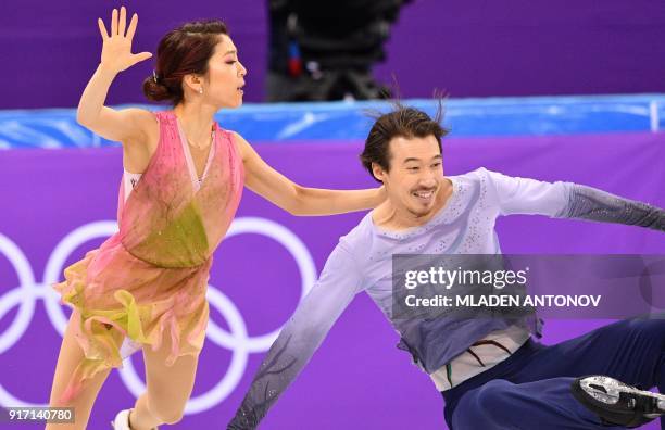 Japan's Chris Reed falls beside Japan's Kana Muramoto as they compete in the figure skating team event ice dance free dance during the Pyeongchang...