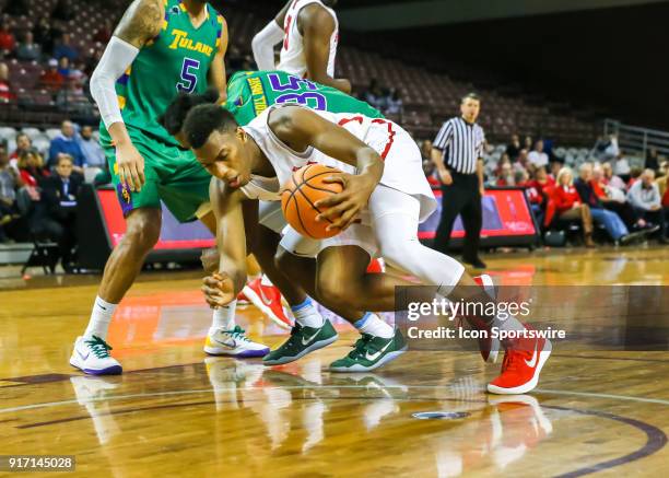 Houston Cougars forward Fabian White Jr. Goes down trying to save the ball during the Men's basketball game between the Tulane Green Wave and Houston...