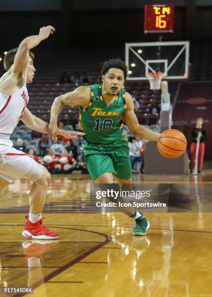 Tulane Green Wave guard Caleb Daniels drives the ball past Houston Cougars guard Wes VanBeck during the Men's basketball game between the Tulane...