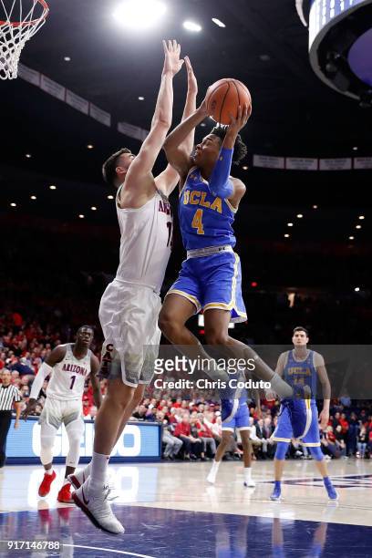 Jaylen Hands of the UCLA Bruins shoots over Dusan Ristic of the Arizona Wildcats during the first half of the college basketball game at McKale...