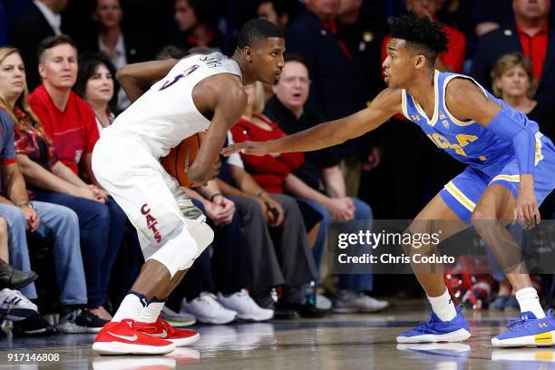 Jaylen Hands of the UCLA Bruins defends Dylan Smith of the Arizona Wildcats during the first half of the college basketball game at McKale Center on...