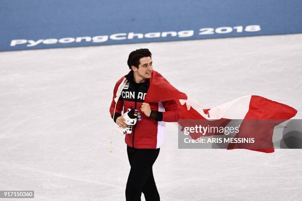 Canada's Scott Moir holds the Canada flag after the venue ceremony after winning gold in the figure skating team event during the Pyeongchang 2018...