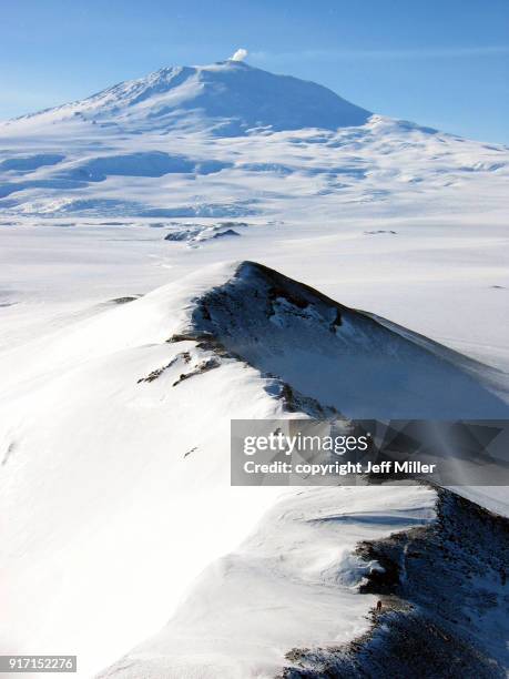 hiker on ridge below mt. erebus, antarctica - mt erebus stock pictures, royalty-free photos & images