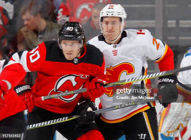 Michael Stone of the Calgary Flames in action against Blake Coleman of the New Jersey Devils on February 8, 2018 at Prudential Center in Newark, New...