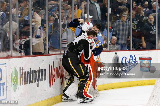 Toledo Walleye goalie Matej Machovsky, of the Czech Republic, , right, and Kansas City Mavericks goalie Mason McDonald , left, fight during a line...