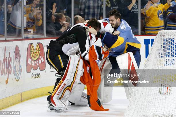 Toledo Walleye goalie Matej Machovsky, of the Czech Republic, , right, and Kansas City Mavericks goalie Mason McDonald , left, fight during a line...