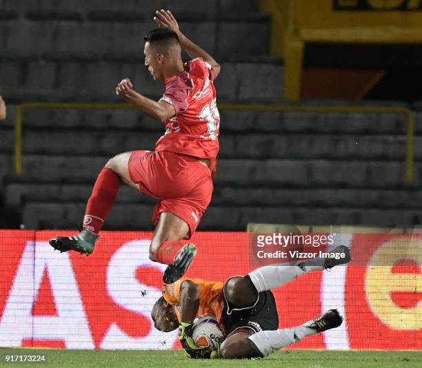 Wuilker Fariñez goalkeeper of Millonarios fights for the ball with Andres Avila of Patriotas Boyaca during a match between Millonarios and Patriotas...