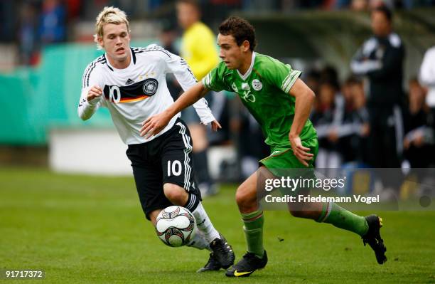 Christopher Buchtmann of Germany and Julien Lopez of Algeria challenge for the ball during the U18 International Friendly match between Germany and...