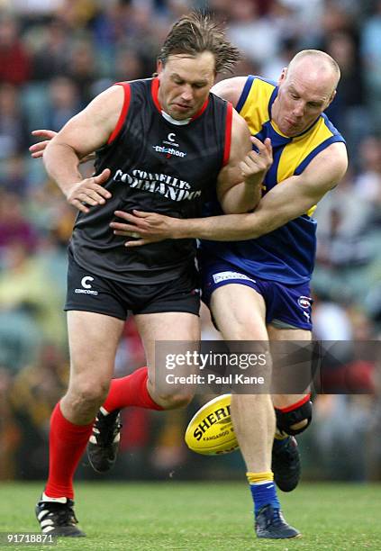 Ashley McIntosh tackles Tony Modra during the Chris Mainwaring charity AFL match at Subiaco Oval on October 10, 2009 in Perth, Australia.