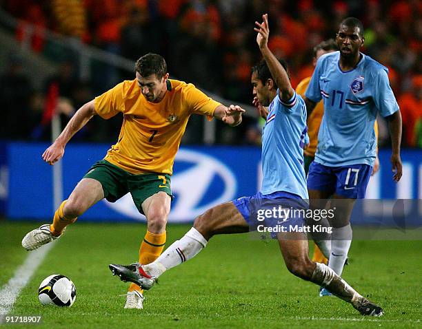 Brett Emerton of the Socceroos controls the ball in front of Giovanni van Bronckhorst of the Netherlands during the International friendly football...