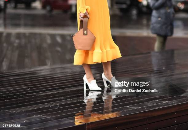 Camila Coelho is seen wearing a Tibi dress and a Danse Lente bag outside the Tibi show during New York Fashion Week: Women's A/W 2018 on February 11,...