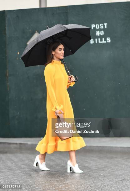 Camila Coelho is seen wearing a Tibi dress and a Danse Lente bag outside the Tibi show during New York Fashion Week: Women's A/W 2018 on February 11,...